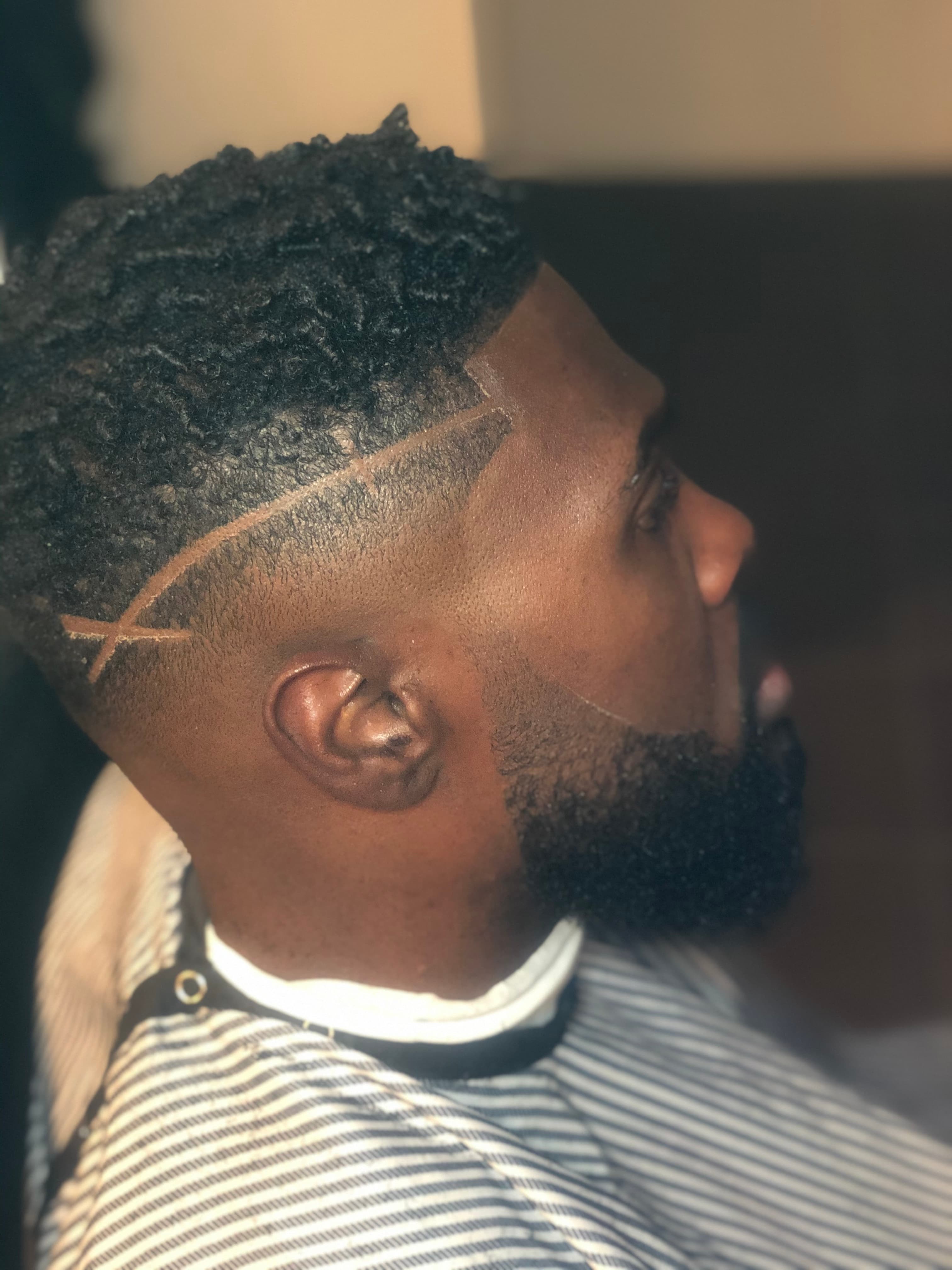 Fade with haircut design and shaped beard by Buck Xperience